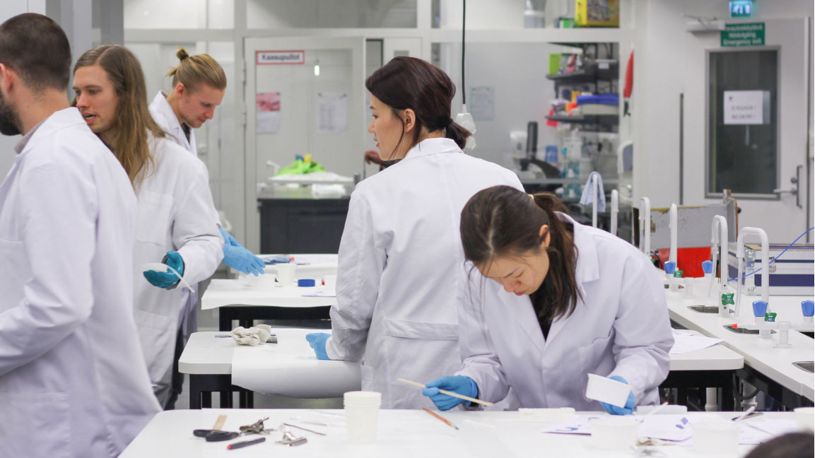 People in white lab coats casting silicone