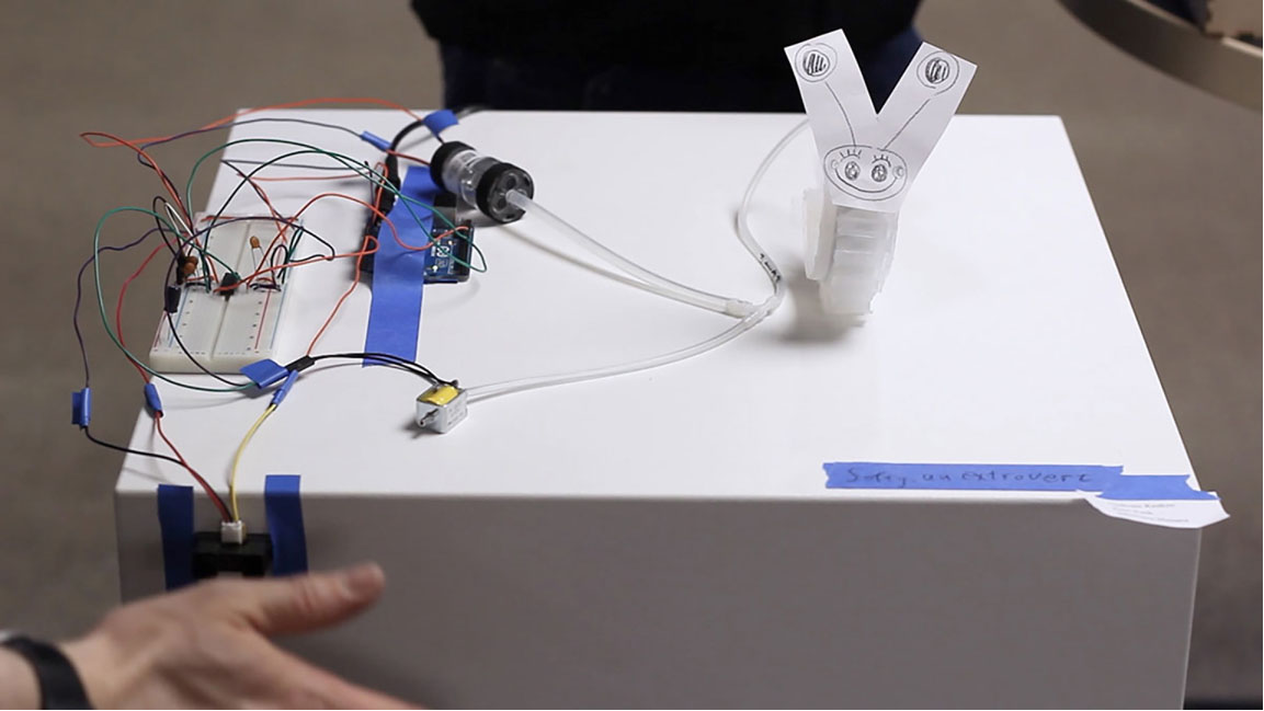 Small silicone actuator with a smiley face activated by contact with a hand
